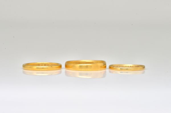 THREE GOLD WEDDING RINGS (3)