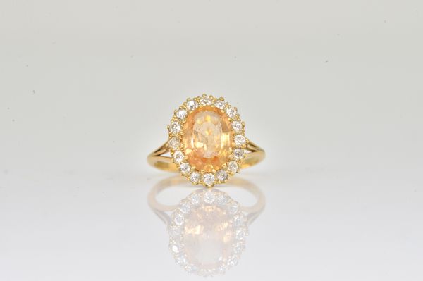 A GOLD, TOPAZ AND DIAMOND OVAL CLUSTER RING