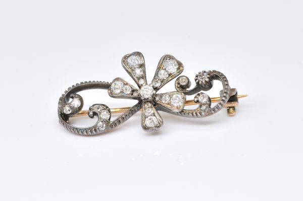 A GOLD BACKED AND SILVER SET DIAMOND FLORAL SPRAY BROOCH