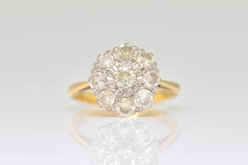 A GOLD AND DIAMOND NINE STONE CLUSTER RING