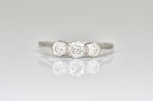 A WHITE GOLD AND DIAMOND THREE STONE RING