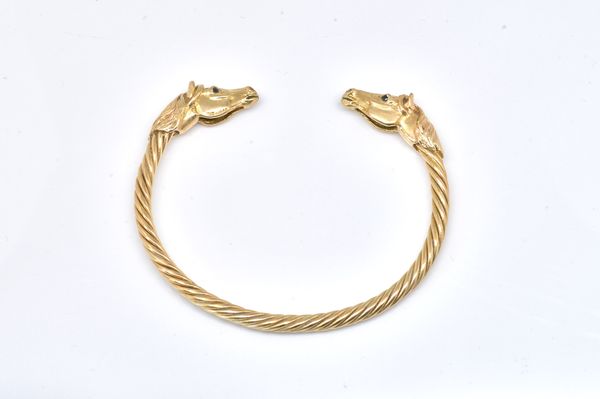 A 9CT GOLD HORSES HEAD BANGLE