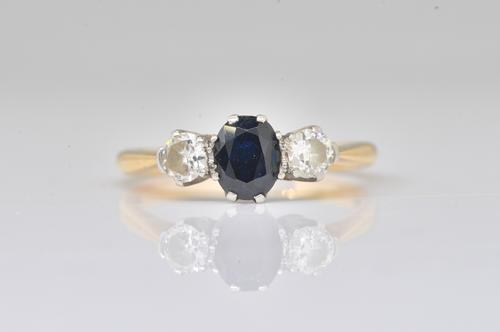 A GOLD AND PLATINUM, SAPPHIRE AND DIAMOND THREE STONE RING