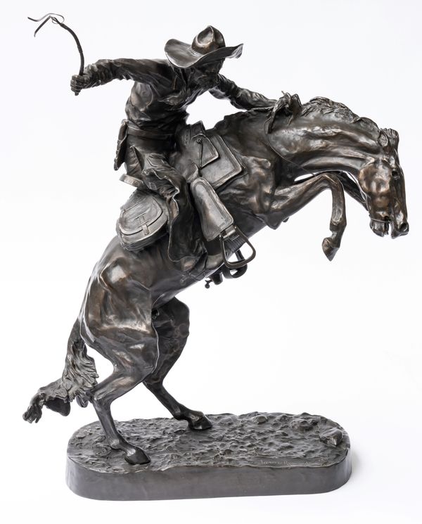 AFTER FREDERIC REMINGTON (AMERICAN, 1861-1909); A BRONZE EQUESTRIAN GROUP OF THE BRONCO BUSTER