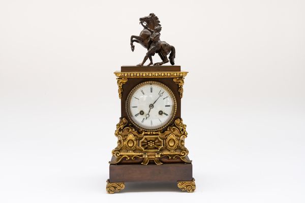 A FRENCH GILT AND PATINATED MANTEL CLOCK