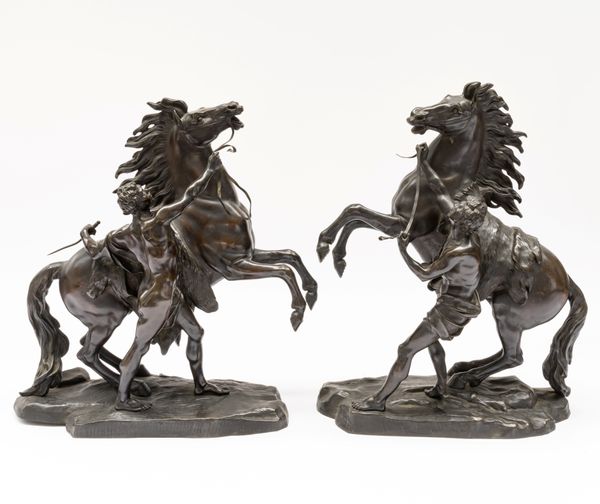 AFTER GUILLAUME COUSTOU THE ELDER (1677-1746);  A PAIR OF BRONZE MODELS OF THE MARLY HORSES (2)