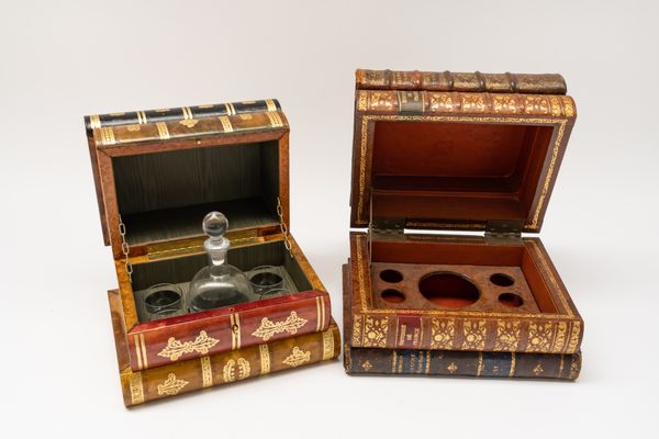 TWO GILT-TOOLED LEATHER COVERED FAUX BOOK TANTALUS CASES