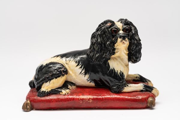 A PAINTED TERRACOTTA MODEL OF KING CHARLES SPANIEL