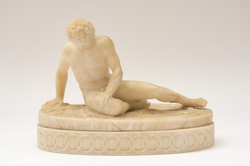 AN ITALIAN CARVED ALABASTER SCULPTURE OF THE DYING GAUL, AFTER THE ANTIQUE