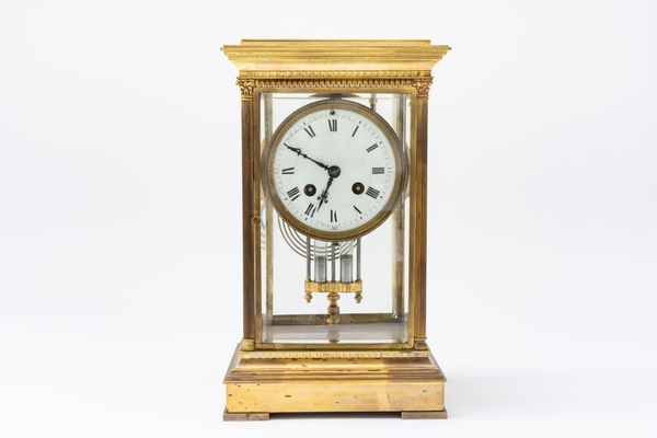 A FRENCH BRASS FOUR GLASS MANTEL CLOCK