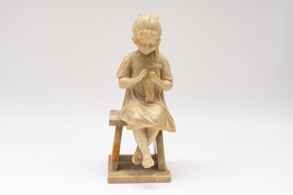 AN ITALIAN CARVED ALABASTER SCULPTURE OF A SEATED GIRL