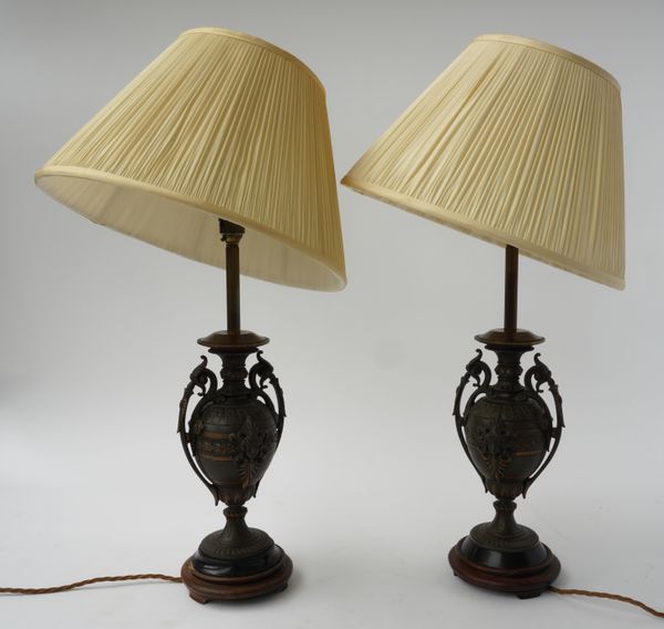 A PAIR OF FRENCH PARCEL-GILT AND PATINATED BRONZE SPELTER URNS ADAPTED TABLE LAMPS