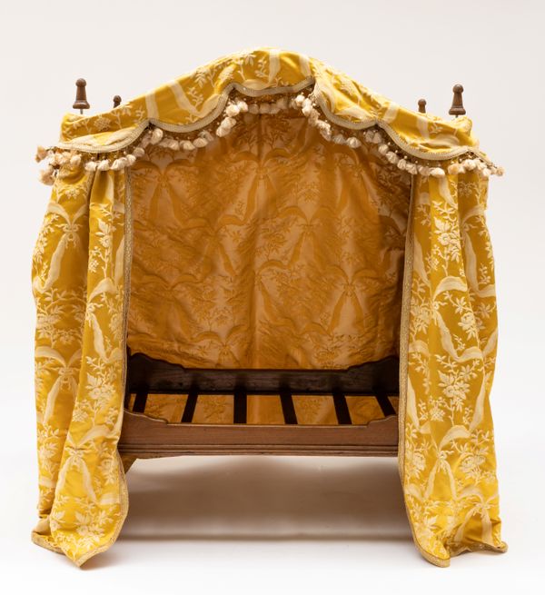 AN EARLY 20TH CENTURY NOVELTY CAT BED FORMED AS A BOBBIN TURNED FOUR POSTER BED