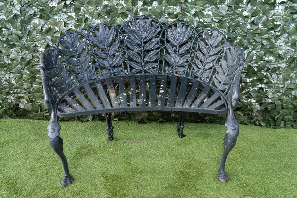 A 20TH CENTURY CAST IRON SEMI-ELLIPTIC GARDEN BENCH WITH FOLIATE CAST BACK