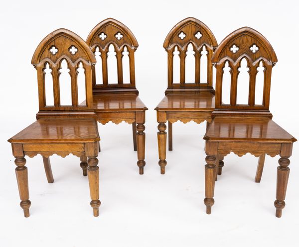 A SET OF FOUR GOTHIC DESIGN ARCH BACK OAK HALL CHAIRS (4)