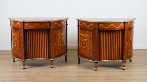 PROVASI: A PAIR OF MARQUETRY INLAID KINGWOOD AND MAHOGANY PARCEL GILT BOWFRONT COMMODES (2)
