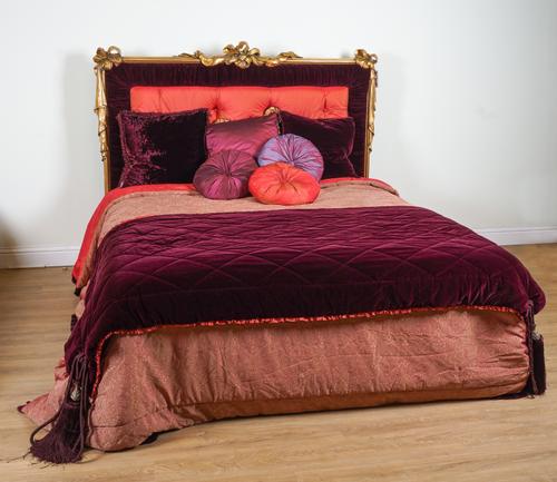 PROVASI: A SUPER KING SIZE BED WITH GILT FRAME RIBBON TIED UPHOLSTERED HEADBOARD