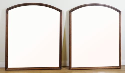 A LARGE PAIR OF ARCH TOP OVERMANTEL MIRRORS (2)