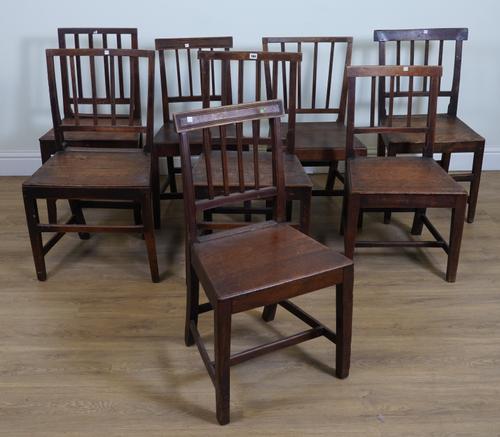 A MATCHED SET OF EIGHT PROVINCIAL OAK STICK BACK DINING CHAIRS (8)