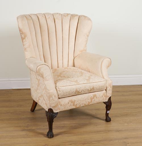 A GEORGE II STYLE SHELL BACK ARMCHAIR ON BALL AND CLAW FEET