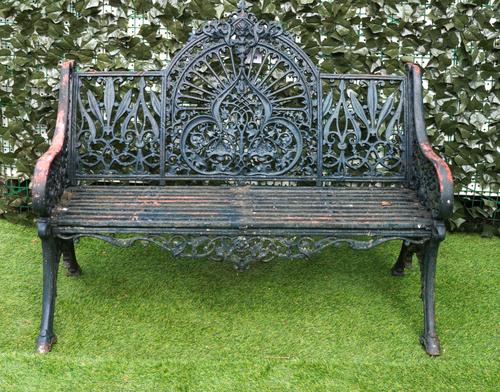 AFTER COALBROOKDALE: A GREEN PAINTED CAST IRON PEACOCK PATTERN BENCH