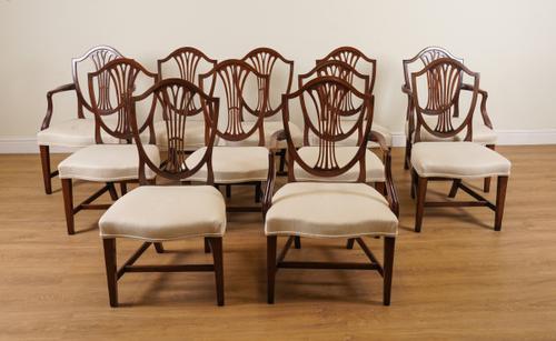 A SET OF ELEVEN GEORGE III STYLE MAHOGANY FRAMED SHIELD BACK DINING CHAIRS (12)