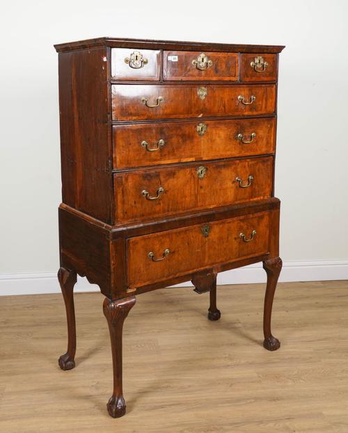 A GEORGE I FEATHER BANDED WALNUT SIX DRAWER CHEST ON SINGLE DRAWER STAND