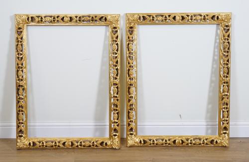A PAIR OF CARVED AND PIERCED GILT RECTANGULAR MIRROR FRAMES (2)