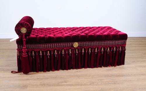 PROVASI: A RECTANGULAR BUTTON BURGUNDY VELVET UPHOLSTERED STOOL
