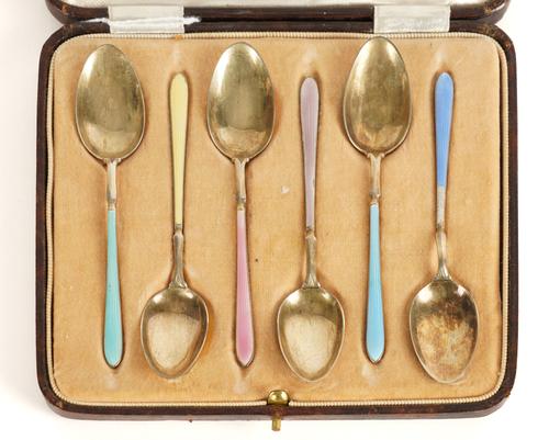 A SET OF SIX SILVER GILT AND VARICOLOURED ENAMEL COFFEE SPOONS