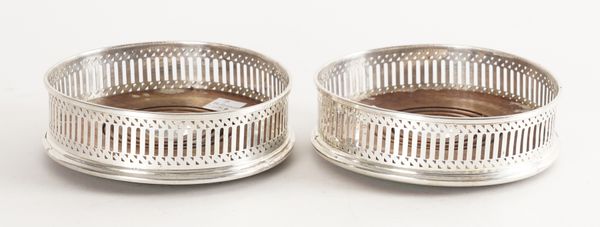 A PAIR OF SILVER MOUNTED BOTTLE COASTERS (2)