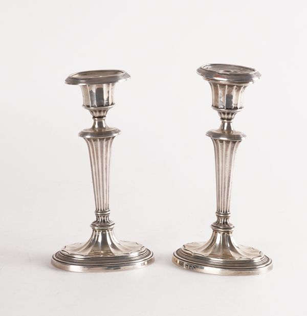 A PAIR OF LATE VICTORIAN SILVER CANDLESTICKS