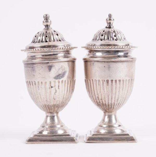 A PAIR OF SILVER PEPPERETTES