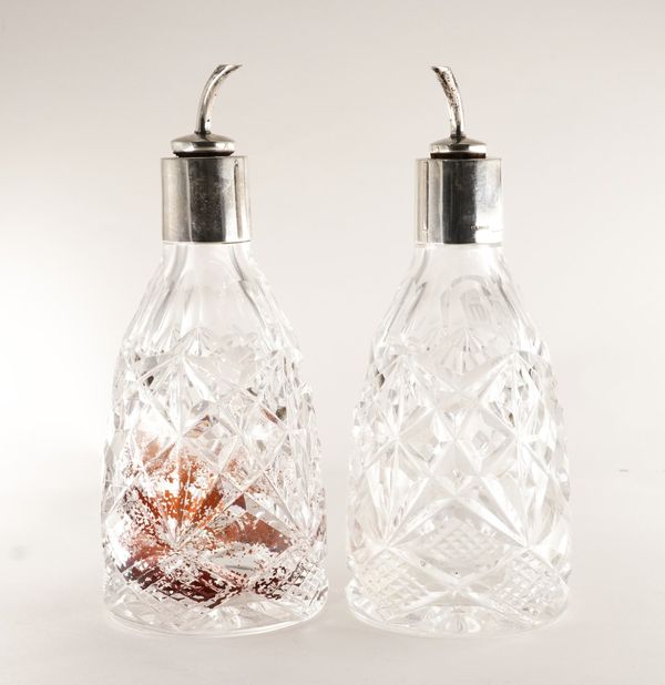 A PAIR OF SILVER MOUNTED FACETED GLASS BITTER'S BOTTLES (2)