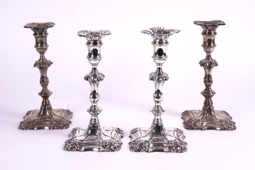 A MATCHED SET OF FOUR 18TH CENTURY SILVER TABLE CANDLESTICKS (4)