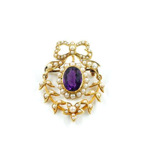 AN EDWARDIAN GOLD, SEED PEARL AND AMETHYST BROOCH