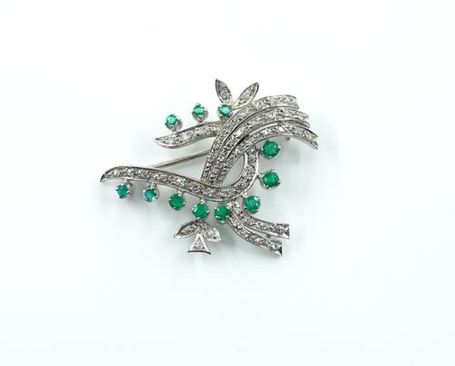 AN EMERALD AND DIAMOND BROOCH