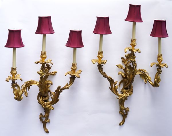 A PAIR OF FRENCH LOUIS XV STYLE ORMOLU THREE LIGHT WALL APPLIQUES (2)