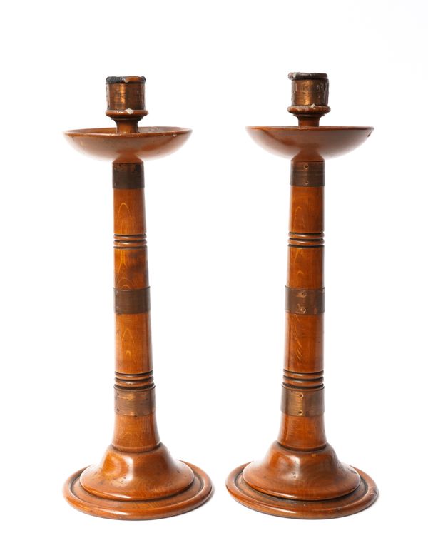 A PAIR OF ARTS AND CRAFTS COPPER AND FRUITWOOD CANDLESTICKS (2)