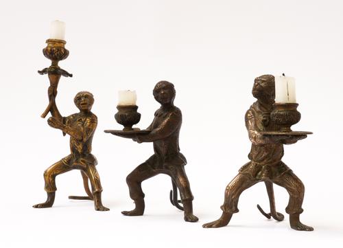 A PAIR OF BRASS MONKEY CANDLESTICK HOLDERS AND ANOTHER (3)