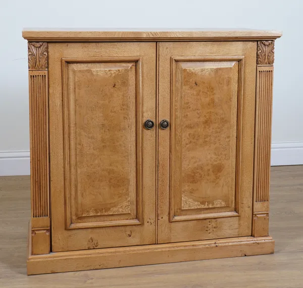 A MODERN OAK TWO DOOR TELEVISION CABINET