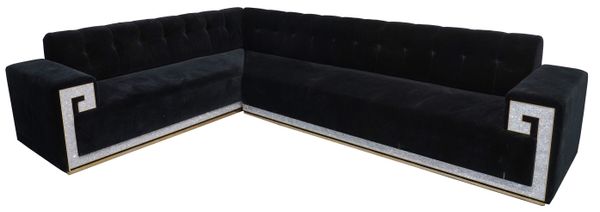 A LARGE BLACK VELVET UPHOLSTERED CORNER SOFA