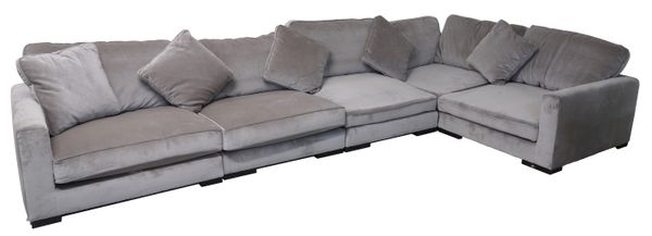 A LARGE GREY UPHOLSTERED CORNER SOFA