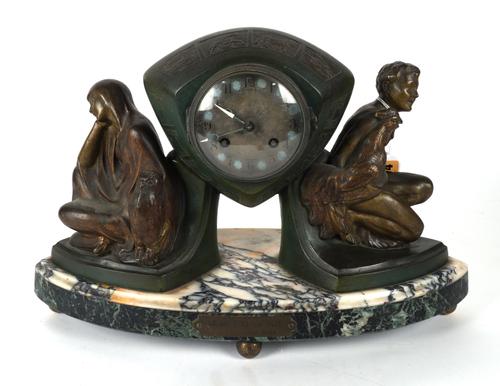 AN ART DECO SPELTER MANTEL CLOCK TITLED DAY AND NIGHT BY P. SEGA