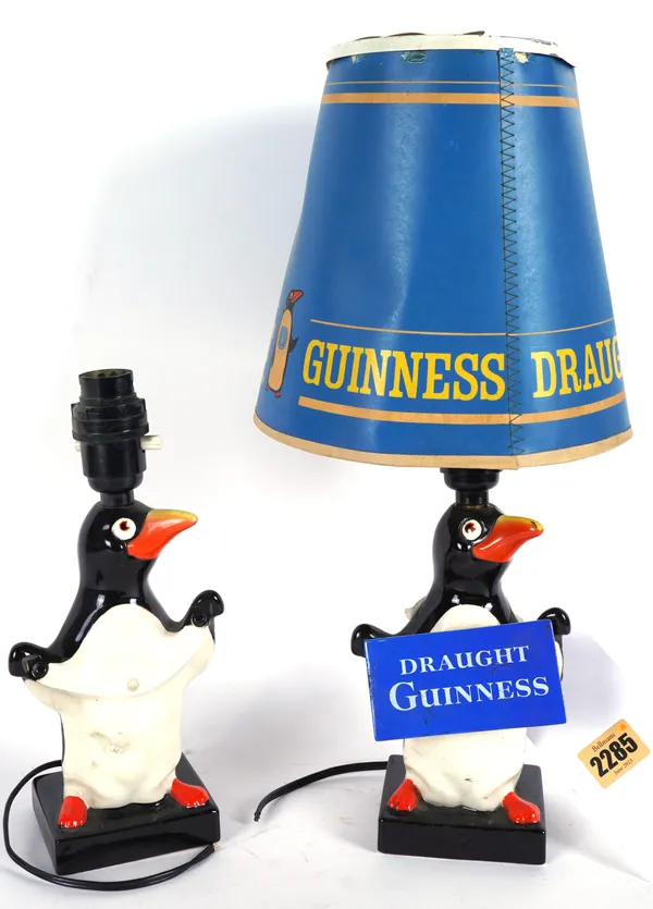 GUINNESS, AN ADVERTISING LAMP BASE MODELLED AS A PENGUIN HOLDING A SIGN WITH SPINNING SHADE (2)