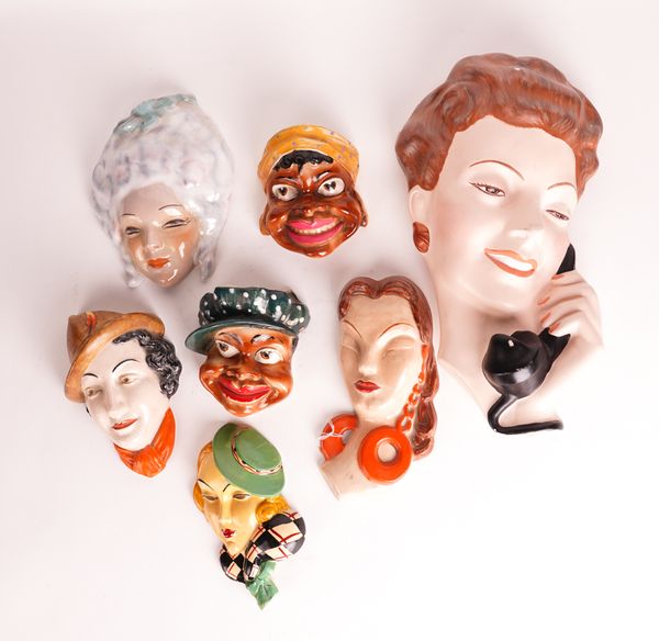 A GROUP OF ART DECO STYLE WALL MASKS INCLUDING ONE BY SUSIE COOPER (7)