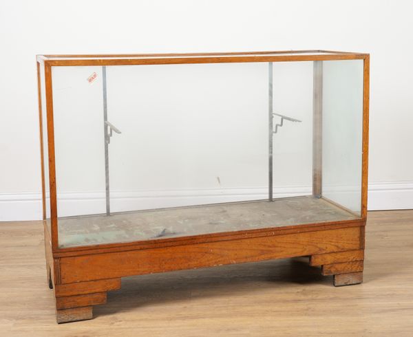 A MID 20TH CENTURY OAK FRAMED GLASS DISPLAY CABINET