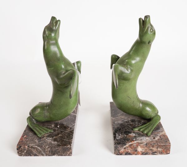 A PAIR OF ART DECO GREEN PATINATED METAL BOOKENDS MODELLED AS A PAIR OF SEALS