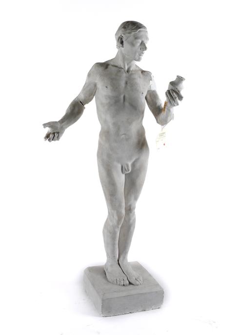 PETER INDUNI (SWISS, 1883-1943); A PLASTER SCULPTED FIGURE OF A YOUNG MAN STUDYING A VASE