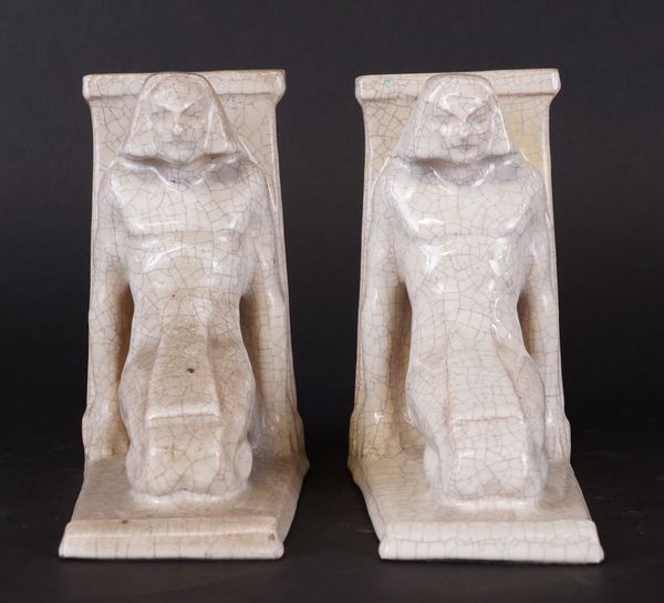 EMILE MONIER (1883-1970): A PAIR OF ART DECO CRACKLE GLAZED CREAMWARE EGYPTIAN SCRIBE BOOKENDS (2)